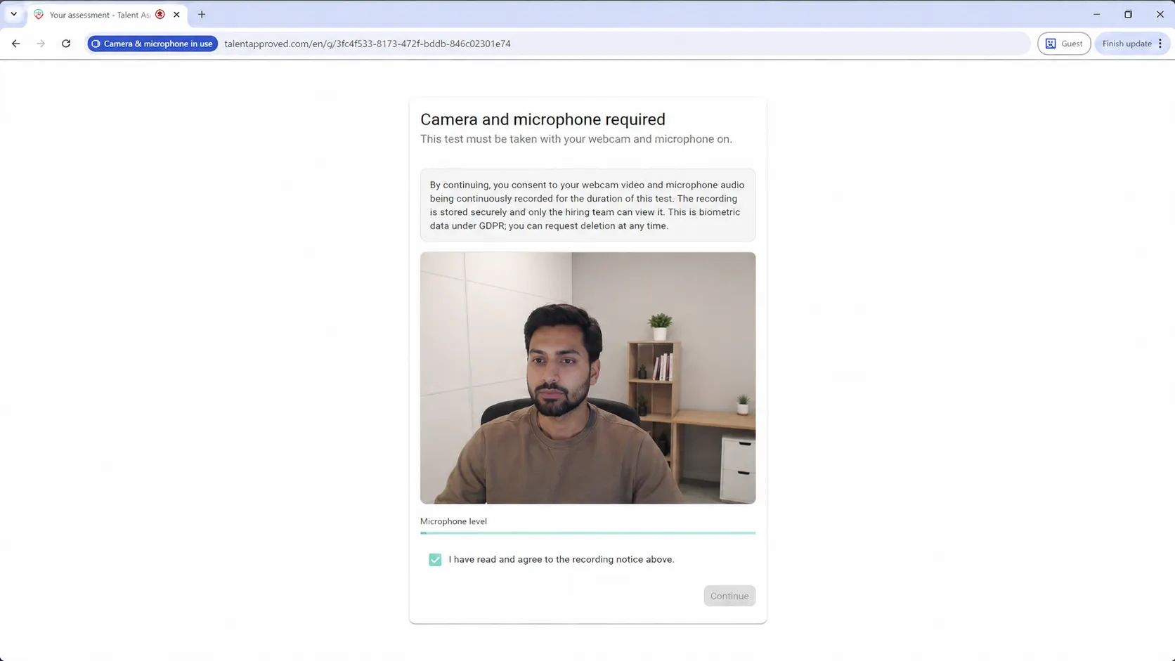 A live webcam preview with a microphone level meter confirming the candidate's devices work